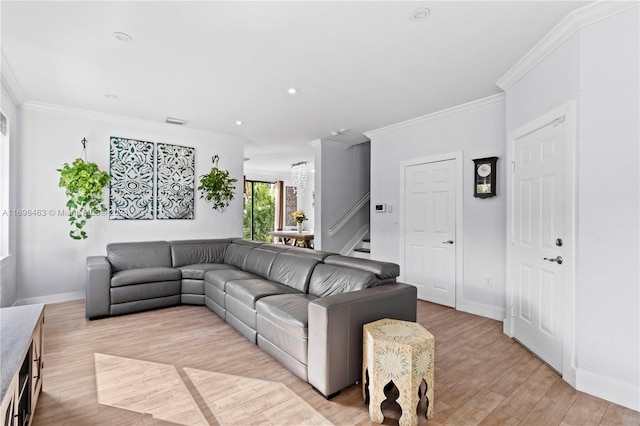 living room with light hardwood / wood-style flooring and ornamental molding