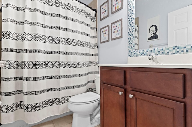 bathroom with tile patterned flooring, vanity, and toilet