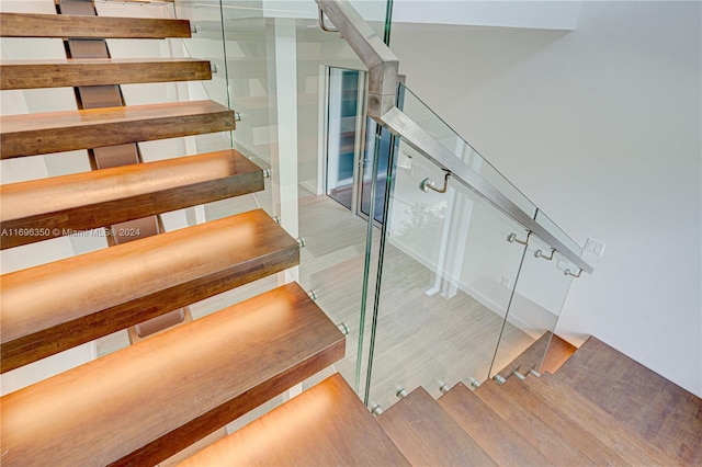 stairway featuring hardwood / wood-style flooring