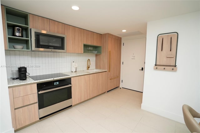 kitchen featuring decorative backsplash, sink, stainless steel appliances, and light brown cabinetry