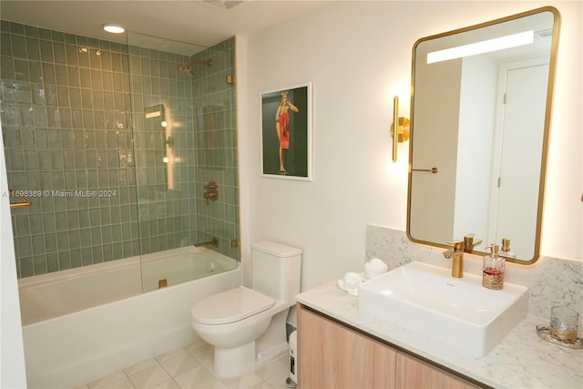 full bathroom featuring tile patterned floors, vanity, tiled shower / bath combo, and toilet