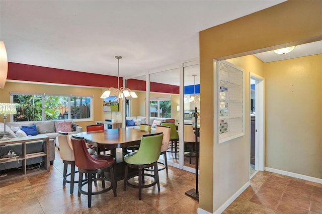 dining space with tile patterned floors and a notable chandelier