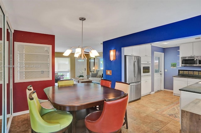 tiled dining area with a chandelier