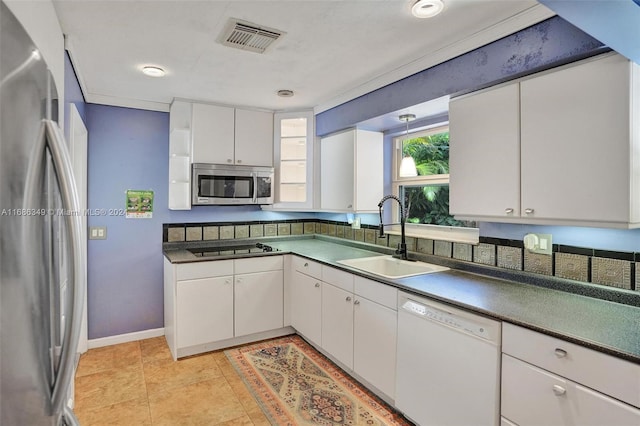 kitchen featuring white cabinets, appliances with stainless steel finishes, light tile patterned flooring, and sink