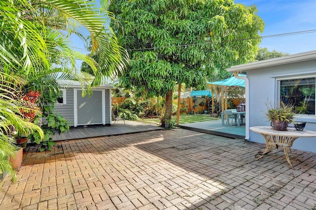 view of patio featuring a storage unit and a wooden deck