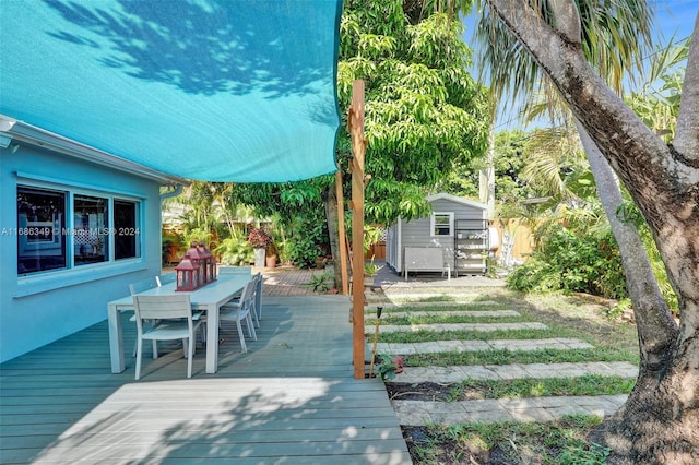 wooden deck featuring a storage unit