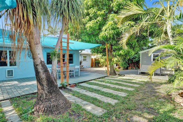 view of yard with a storage unit and a wooden deck