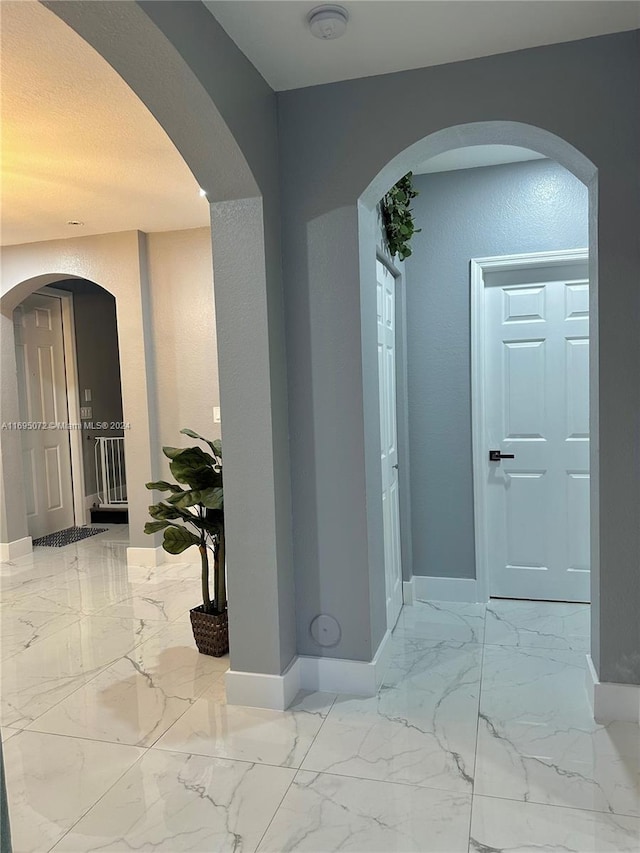 hallway featuring a textured ceiling