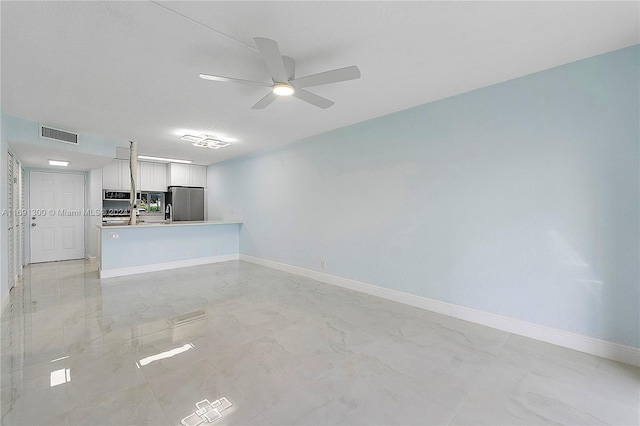 unfurnished living room featuring ceiling fan