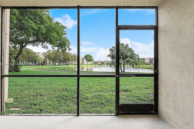 unfurnished sunroom with a water view