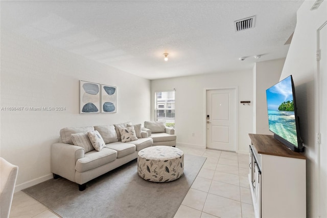 living room featuring light tile patterned floors and a textured ceiling