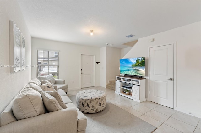 living room featuring light tile patterned floors and a textured ceiling