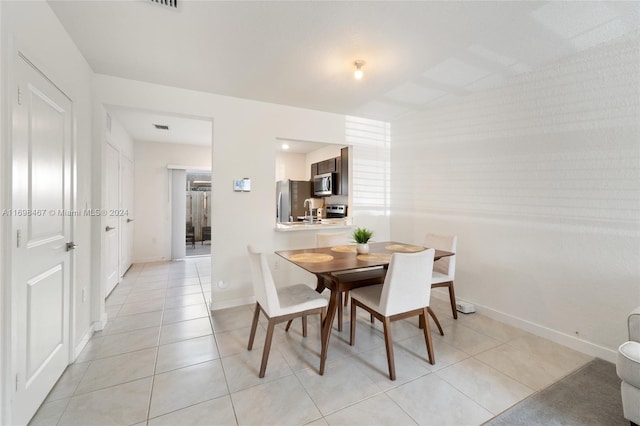 dining room with light tile patterned flooring and sink