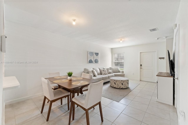 dining space featuring light tile patterned flooring