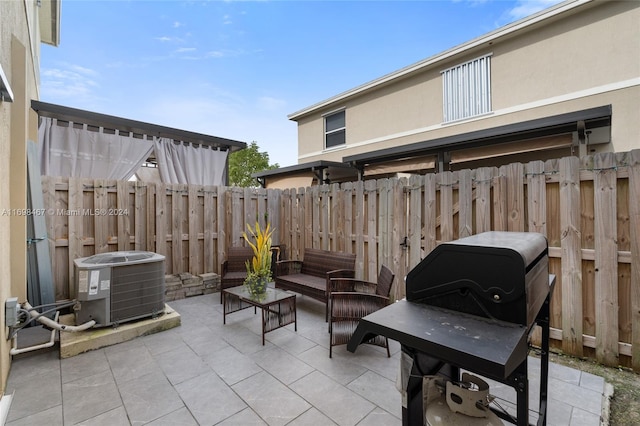 view of patio featuring a grill, cooling unit, and an outdoor hangout area