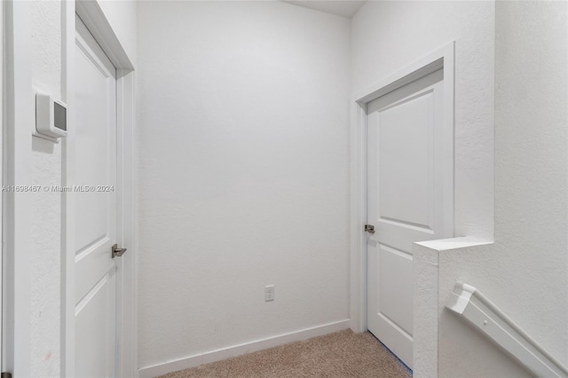 hallway with light colored carpet