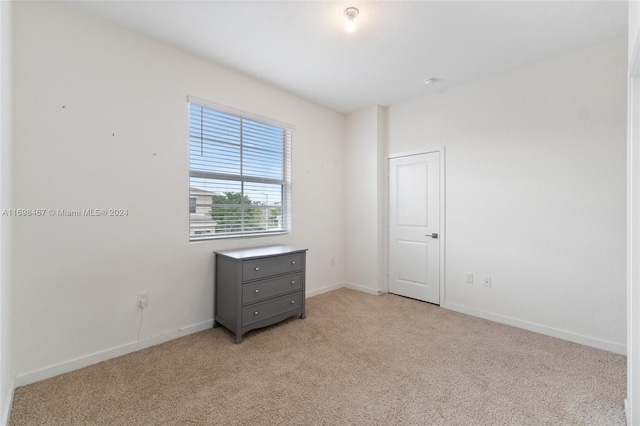 empty room featuring light colored carpet