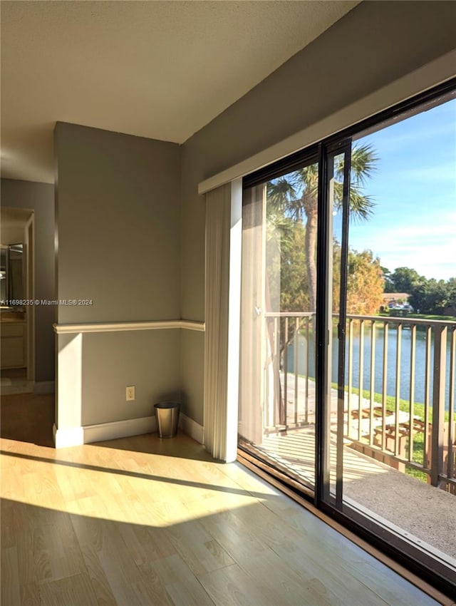 interior space featuring a water view and light hardwood / wood-style floors