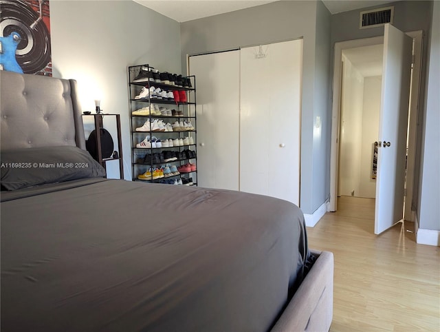 bedroom with a closet and light hardwood / wood-style flooring