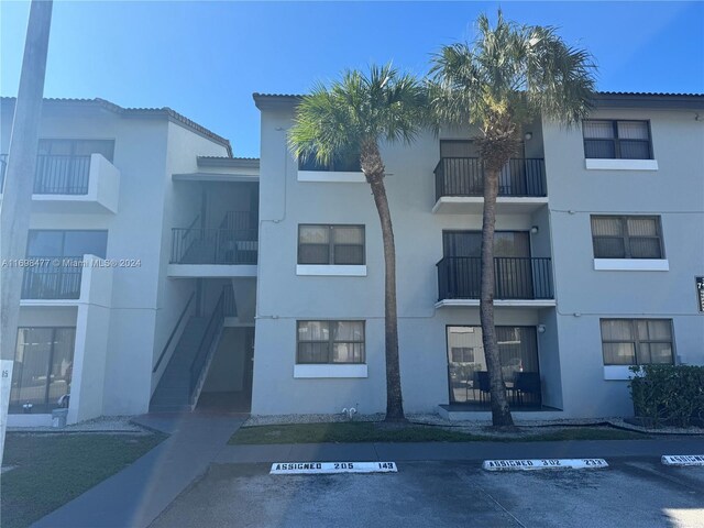 7135 NW 179th St Unit 209, Hialeah, FL 33015 - view of property with uncovered parking