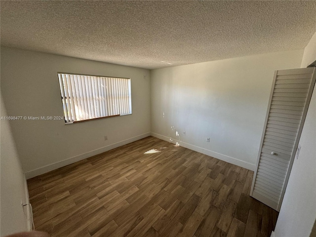 7135 NW 179th St Unit 209, Hialeah, FL 33015 - unfurnished room featuring wood finished floors and a textured ceiling