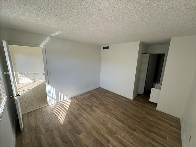 7135 NW 179th St Unit 209, Hialeah, FL 33015 - empty room featuring dark wood-style flooring and a textured ceiling