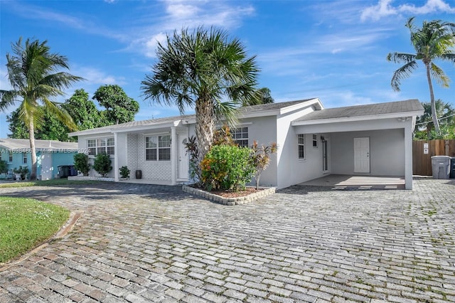 single story home featuring a carport