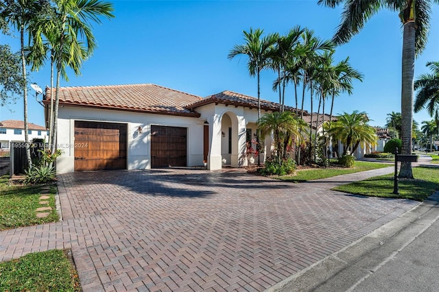 mediterranean / spanish house featuring a garage