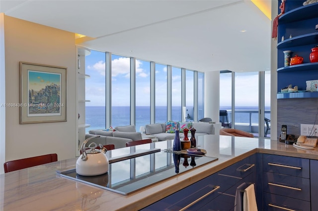 kitchen with a water view and expansive windows