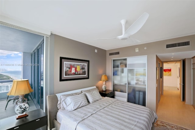 bedroom with ceiling fan, a closet, and light hardwood / wood-style floors