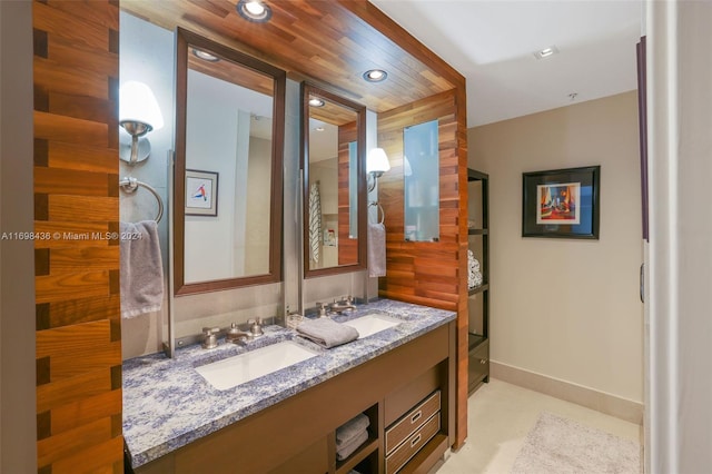 bathroom featuring vanity and wooden walls