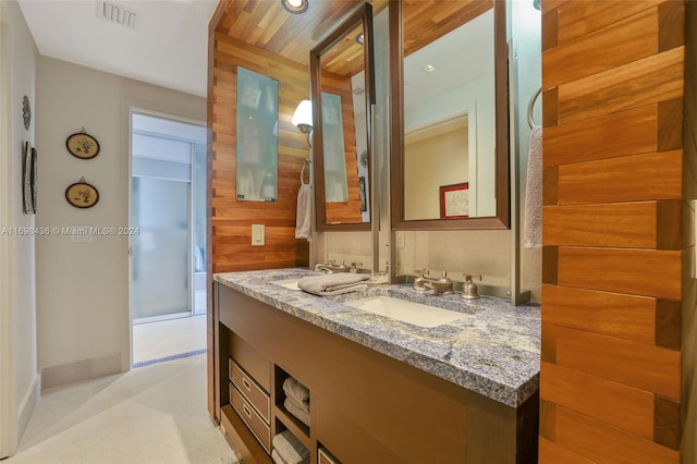 bathroom featuring wooden walls, vanity, and wooden ceiling