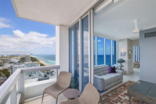 balcony featuring a water view and a beach view