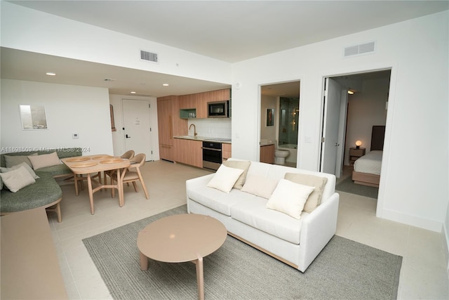 tiled living room featuring sink