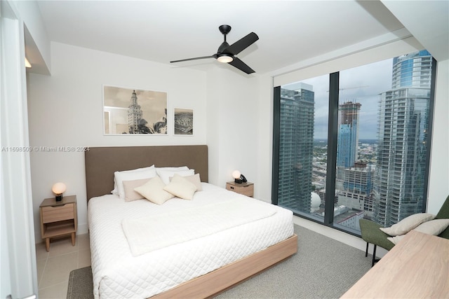 tiled bedroom with access to exterior and ceiling fan