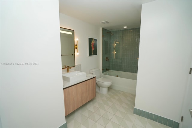 full bathroom with tile patterned flooring, vanity, toilet, and tiled shower / bath