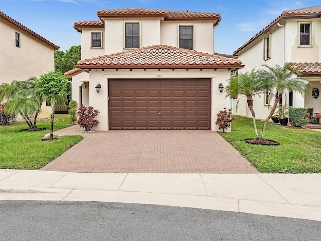 mediterranean / spanish house featuring a front yard and a garage