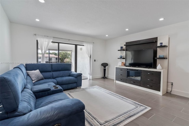 living room with light hardwood / wood-style floors and a textured ceiling