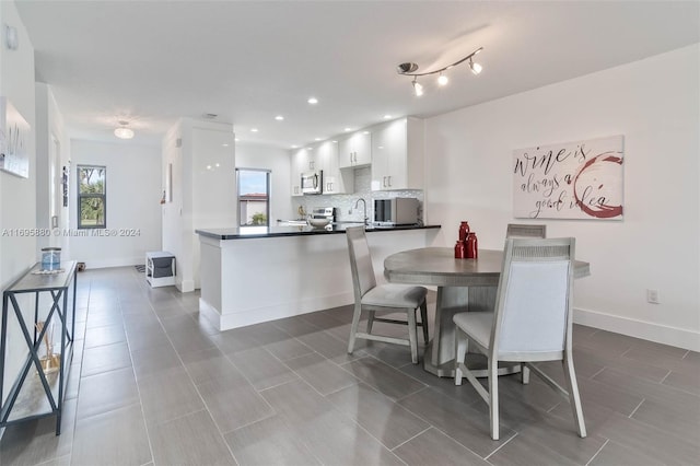 tiled dining room with sink