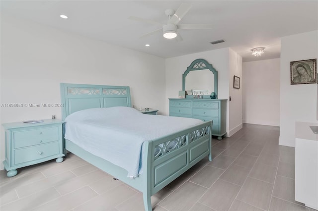 tiled bedroom featuring ceiling fan