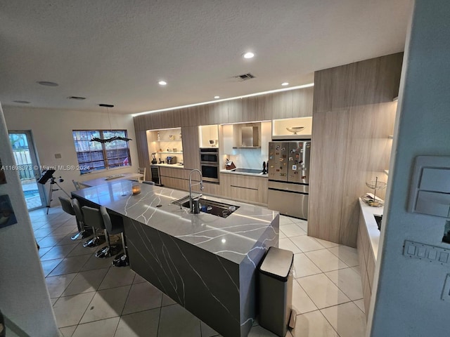 kitchen featuring a breakfast bar, sink, light tile patterned floors, and stainless steel appliances