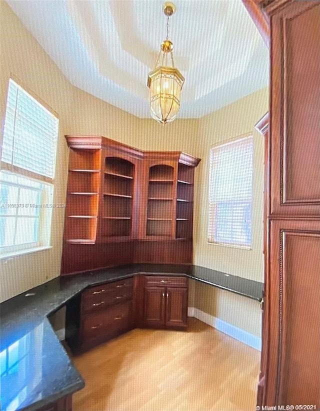 unfurnished office featuring an inviting chandelier