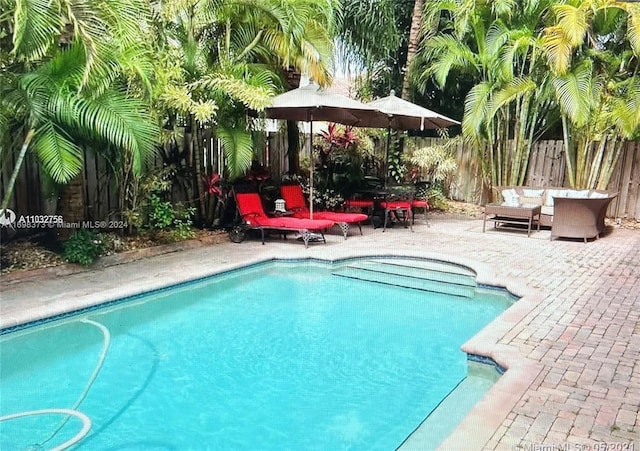 view of swimming pool featuring a patio