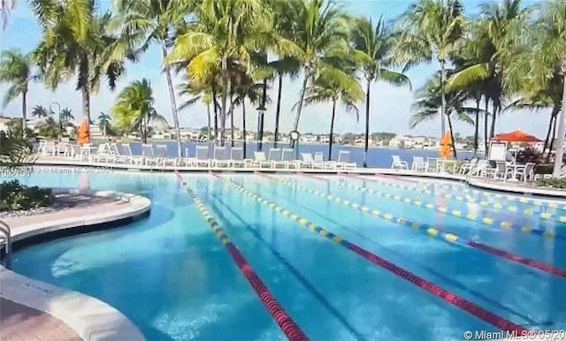 view of swimming pool with a water view