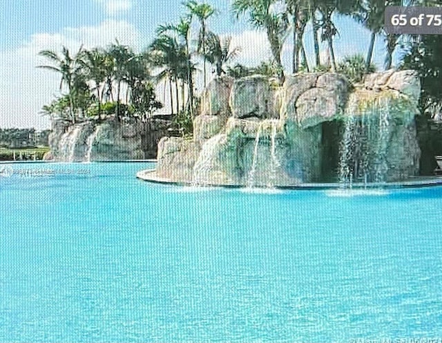 view of pool featuring a water view