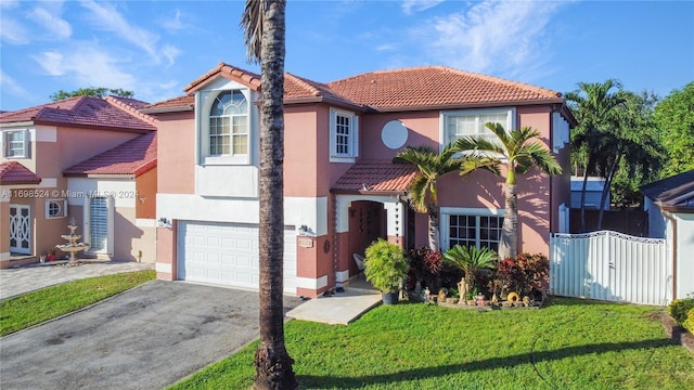 mediterranean / spanish home with a front yard and a garage