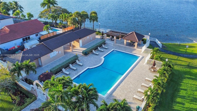 view of pool with a water view, a pergola, and a patio area