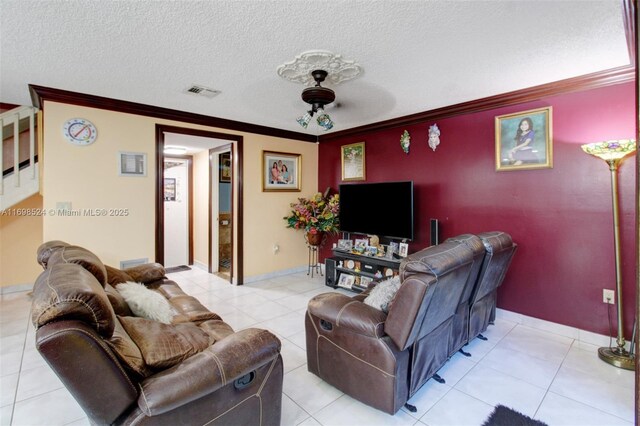 tiled living room featuring crown molding and a textured ceiling