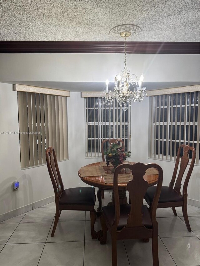 tiled dining area featuring an inviting chandelier