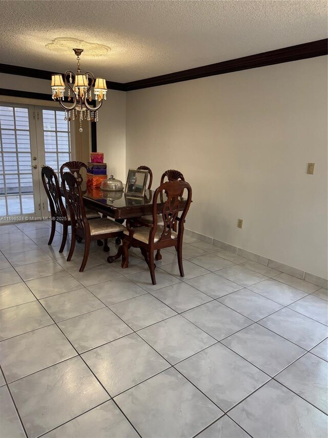 dining area featuring light tile patterned flooring, a textured ceiling, crown molding, and an inviting chandelier